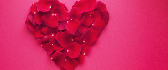 Red rose petals forming heart-shape